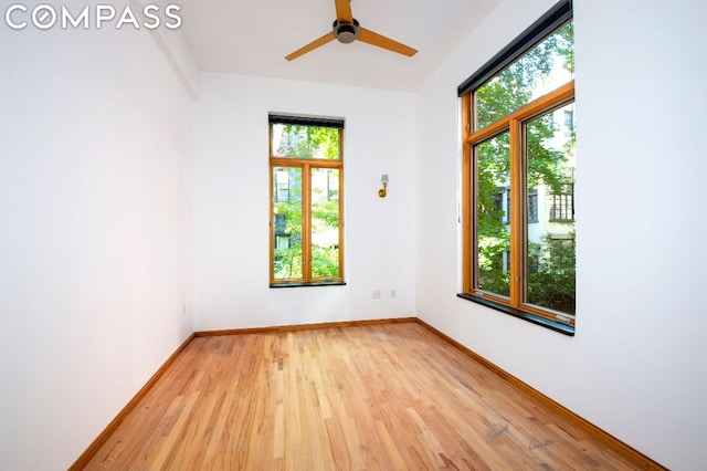 spare room featuring ceiling fan, plenty of natural light, and light hardwood / wood-style flooring