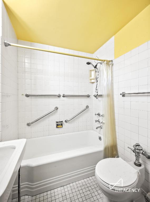 full bathroom featuring toilet, shower / tub combo, tile patterned flooring, and sink