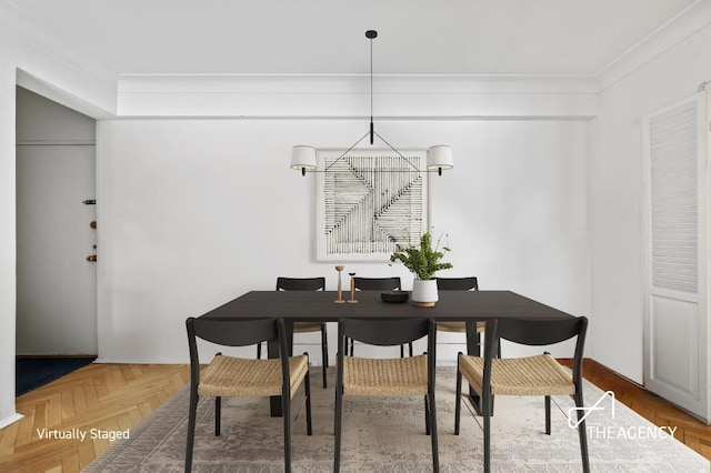 dining room with crown molding, parquet floors, and an inviting chandelier