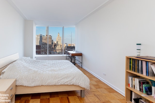 bedroom with light parquet floors and ornamental molding