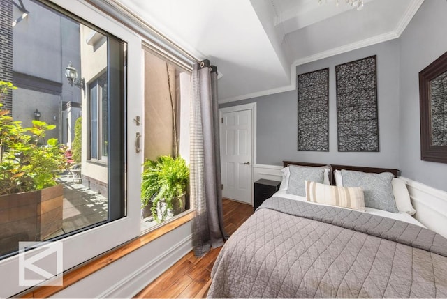 bedroom with ornamental molding and hardwood / wood-style floors