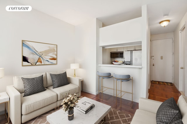 living room featuring dark parquet flooring