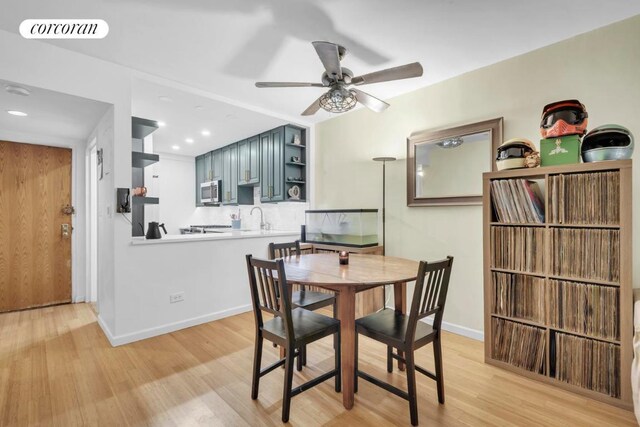 dining space featuring sink, light hardwood / wood-style floors, and ceiling fan