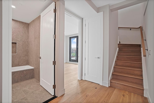 stairs featuring wood-type flooring