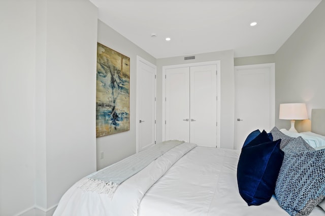 bedroom with recessed lighting, visible vents, and a closet