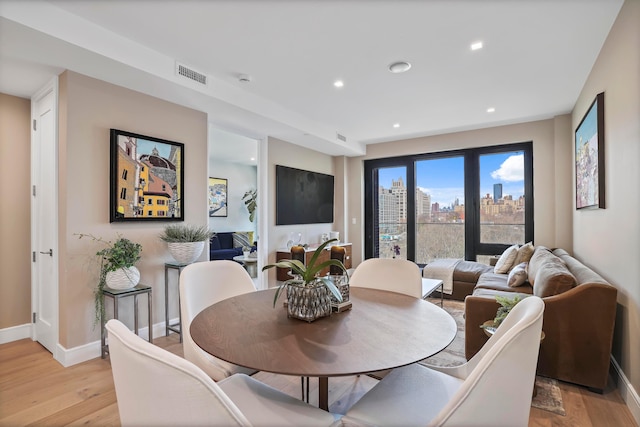 dining room with recessed lighting, light wood-style floors, visible vents, and baseboards