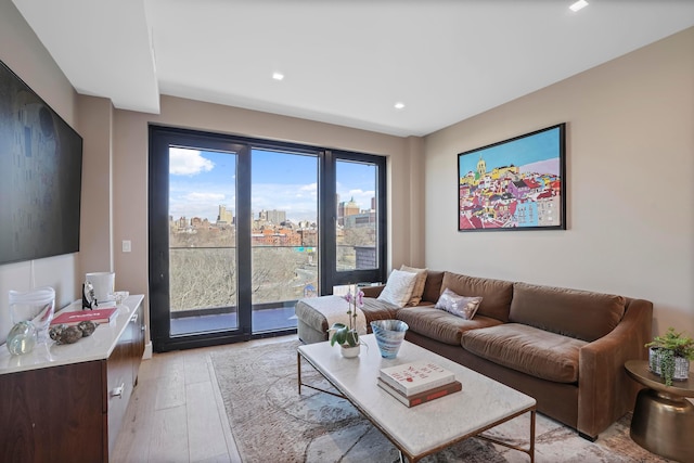 living area featuring recessed lighting, a view of city, and light wood-type flooring