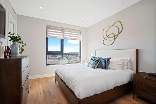 bedroom featuring light wood finished floors, recessed lighting, and baseboards