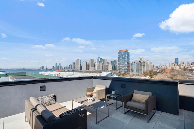 view of patio with a view of city, a balcony, and outdoor lounge area