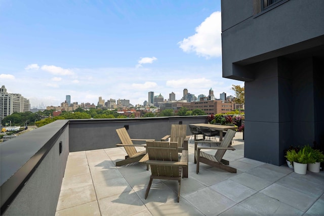 view of patio / terrace with a view of city and a balcony