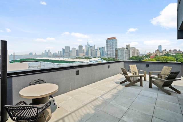 view of patio with a balcony and a city view