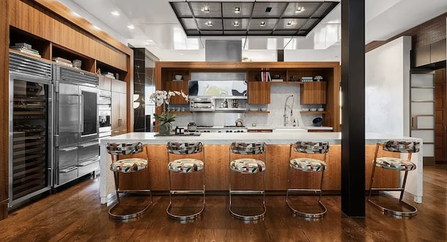 kitchen featuring brown cabinets, modern cabinets, light countertops, and open shelves