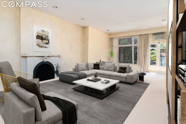 carpeted living room featuring a wall mounted AC