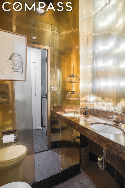 bathroom with tile patterned flooring, sink, and toilet