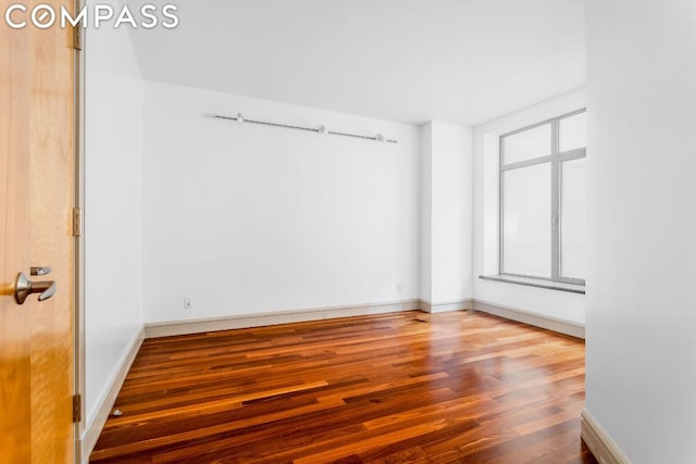 unfurnished room with hardwood / wood-style floors