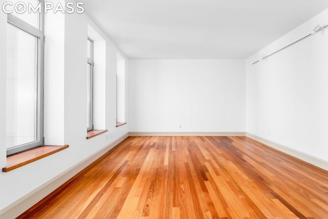 spare room with light hardwood / wood-style flooring