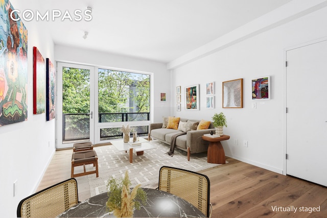 living area featuring wood finished floors and baseboards