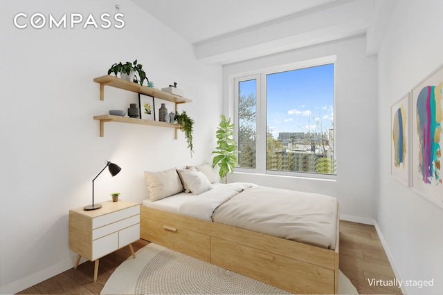 bedroom with wood finished floors and baseboards