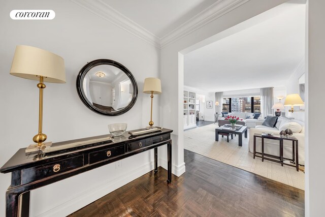 hallway featuring crown molding and dark parquet flooring