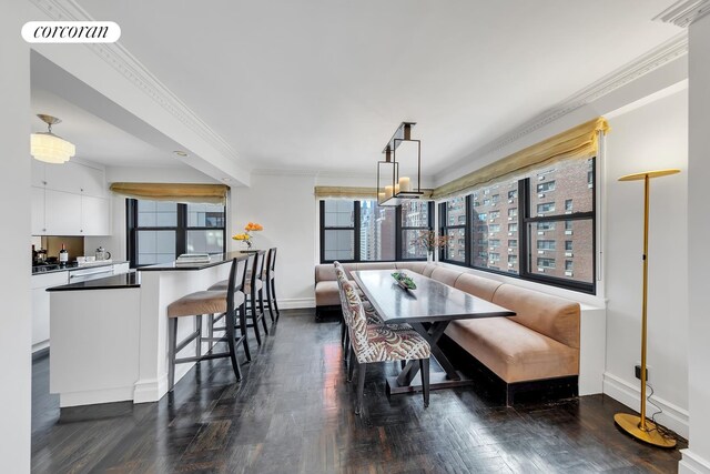 dining room featuring crown molding, dark hardwood / wood-style flooring, and breakfast area