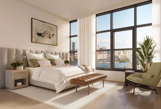 bedroom featuring wood-type flooring, a wall of windows, and a water view