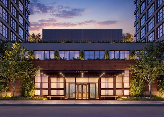 view of outdoor building at dusk