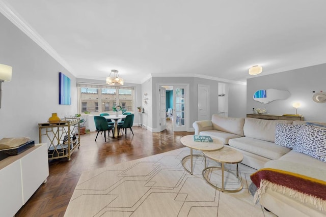 living room featuring a notable chandelier, ornamental molding, and dark parquet floors