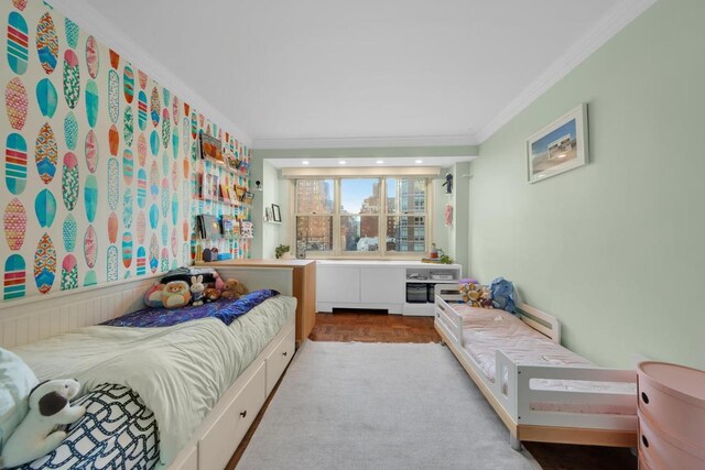 bedroom with light parquet floors and ornamental molding