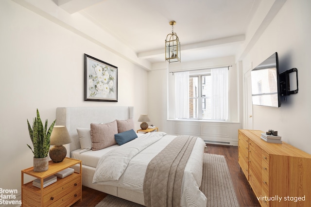 bedroom with beamed ceiling and dark wood-type flooring