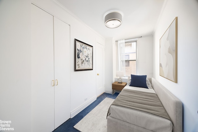 bedroom with crown molding, carpet, and baseboards