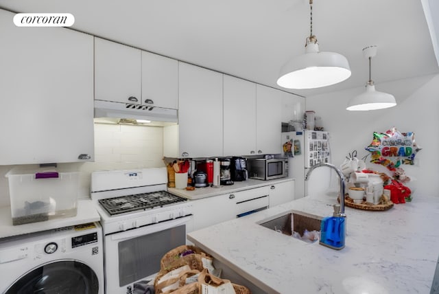 kitchen with sink, white appliances, white cabinetry, washer / dryer, and decorative light fixtures