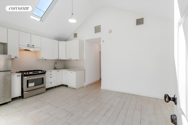 kitchen with white cabinetry, stainless steel appliances, decorative light fixtures, and a skylight