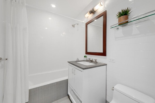 full bathroom featuring shower / tub combo, vanity, tile walls, and toilet