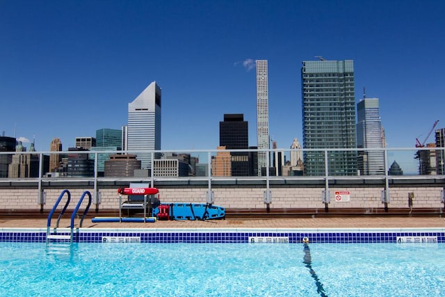 view of swimming pool with a view of city