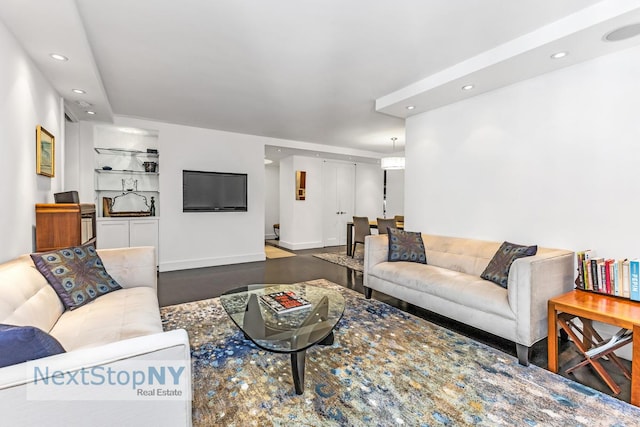 living area with recessed lighting and wood finished floors