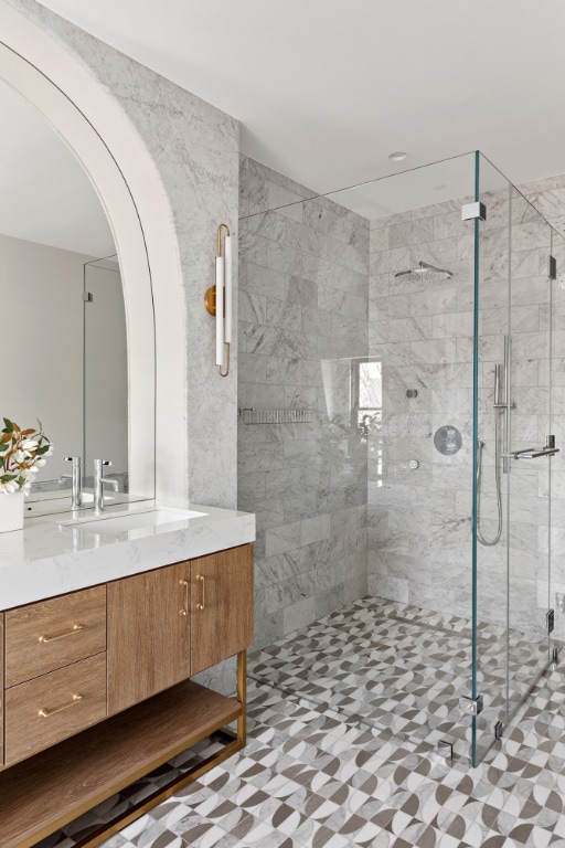 bathroom featuring an enclosed shower and vanity