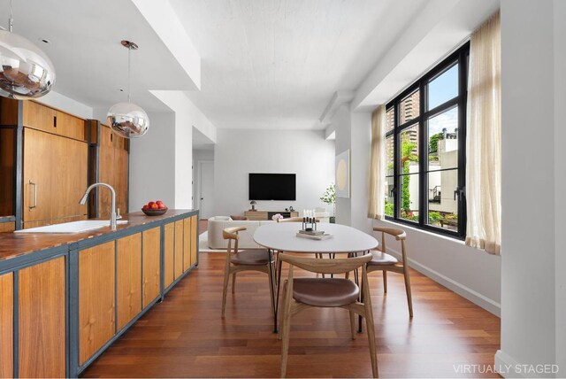 dining room with sink and dark hardwood / wood-style floors