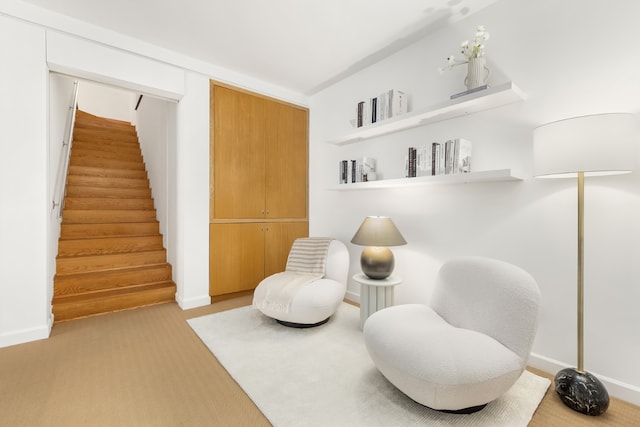 sitting room featuring light colored carpet