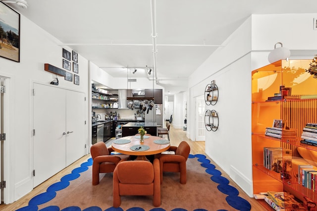 dining room featuring light wood-style floors and track lighting