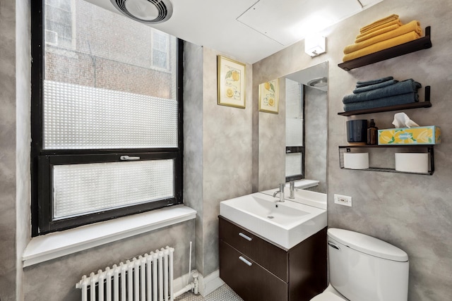 bathroom featuring radiator heating unit, vanity, and toilet