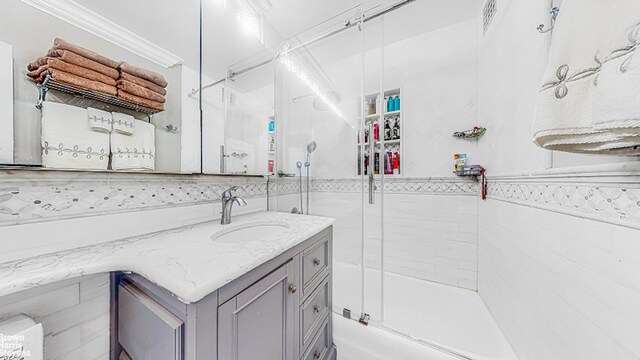 345 E 80th St Unit 19Ef, New York City, NY 10028 - bathroom with vanity and bath / shower combo with glass door