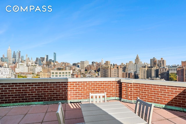 view of patio / terrace with a balcony and a city view