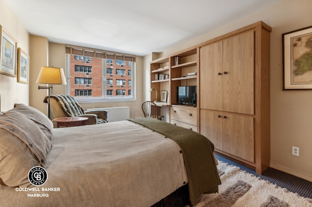 bedroom featuring light carpet and baseboards