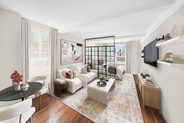 living area featuring baseboards and wood finished floors