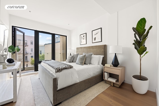 bedroom with access to outside and wood-type flooring