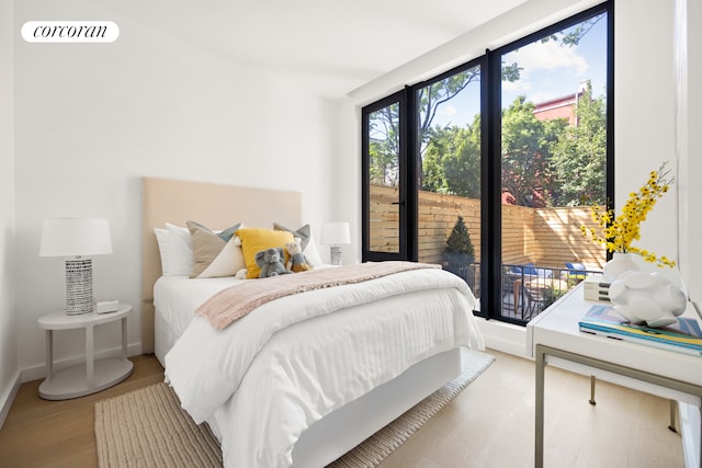 bedroom with visible vents, access to outside, baseboards, and light wood-type flooring