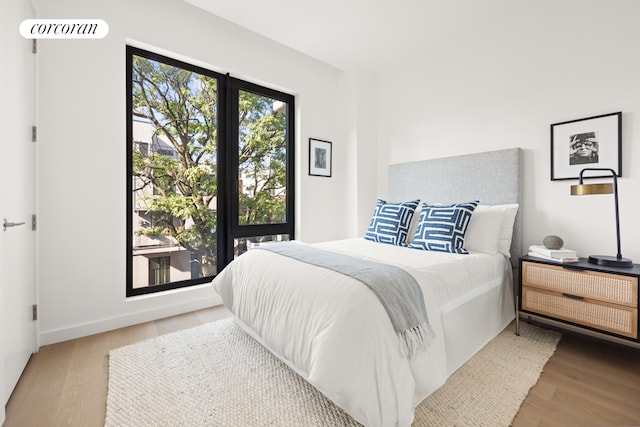 bedroom with wood finished floors and visible vents