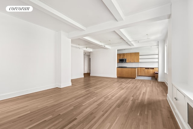 unfurnished living room with beamed ceiling, coffered ceiling, and light hardwood / wood-style floors