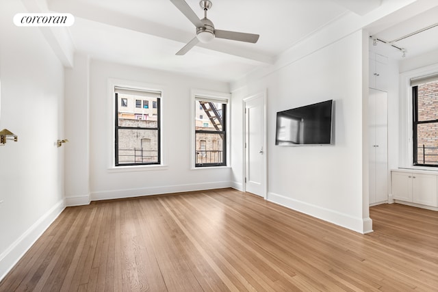 unfurnished living room with ceiling fan and light wood-type flooring