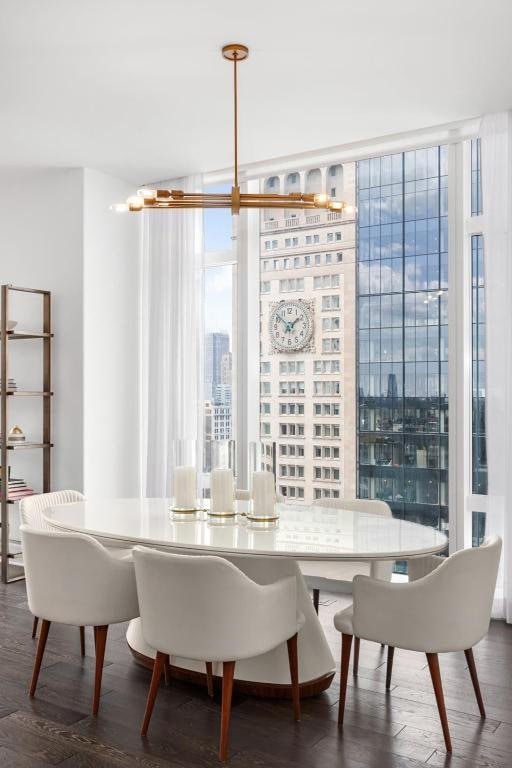 dining room with dark hardwood / wood-style floors and expansive windows